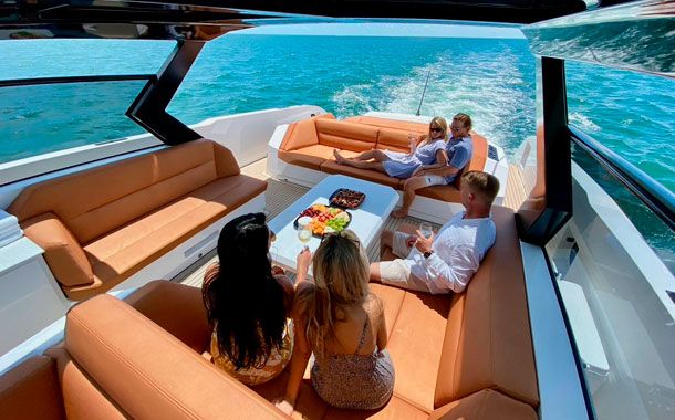 A family enjoying its Vanquish Yacht in Ibiza
