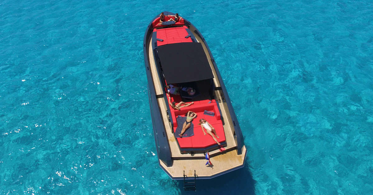 Sleek Vanquish yacht cruising along the Ibiza coastline